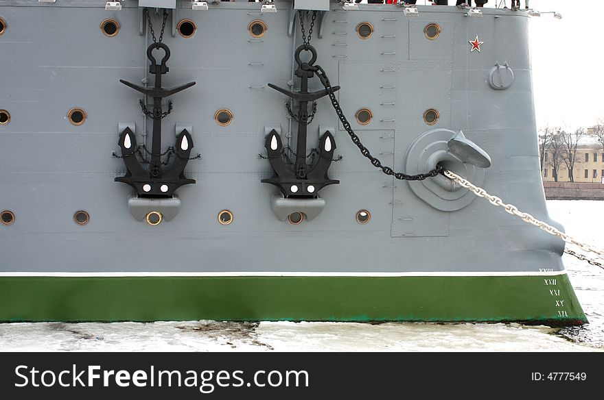 Two anchors, chains, bow windows at the old big Russian warship - cruiser