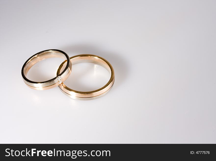 Golden rings on a neutral white backround