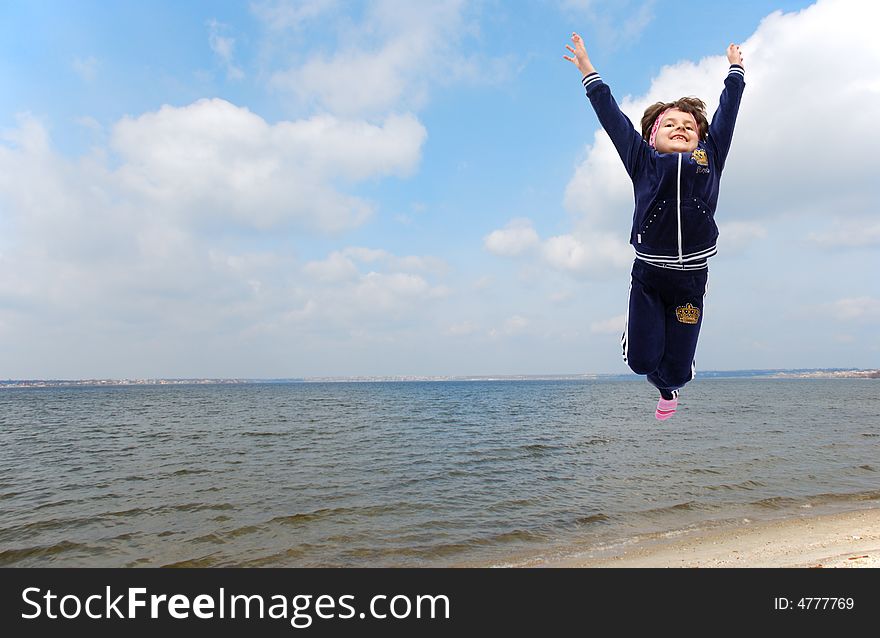 Jumping child on river background