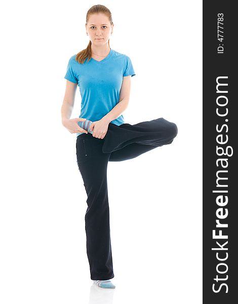 The young woman doing yoga exercise isolated on a white background