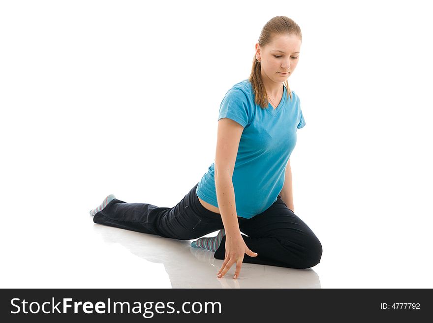 The young woman doing yoga exercise isolated on a white background