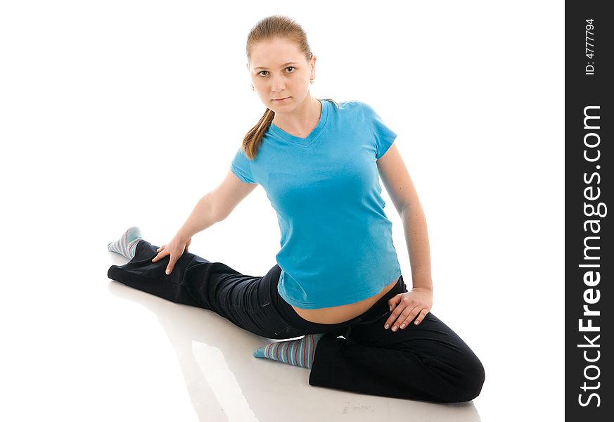 The beautiful young woman doing yoga exercise isolated on a white background. The beautiful young woman doing yoga exercise isolated on a white background