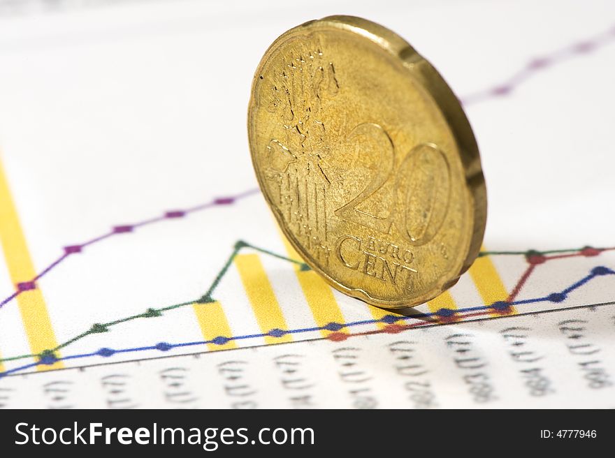 Euro coins on financial graphs. close-up. Color. Euro coins on financial graphs. close-up. Color.