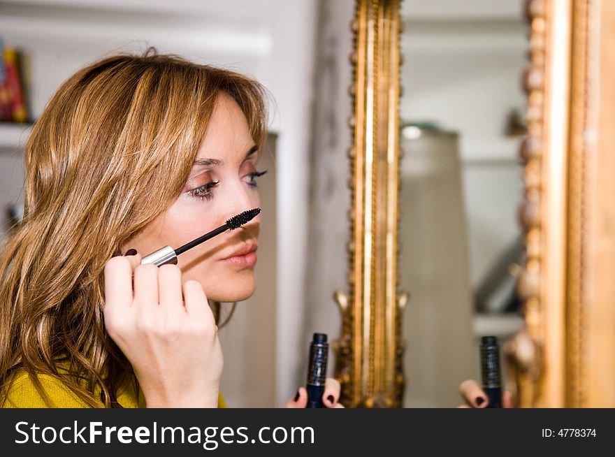 Woman applying cosmetic with applicator. Make-up treatment. Woman applying cosmetic with applicator. Make-up treatment.