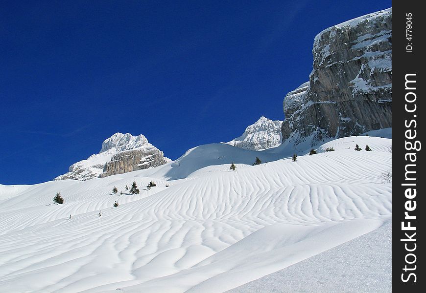 Winter mountains covered with snow and blue sky, France