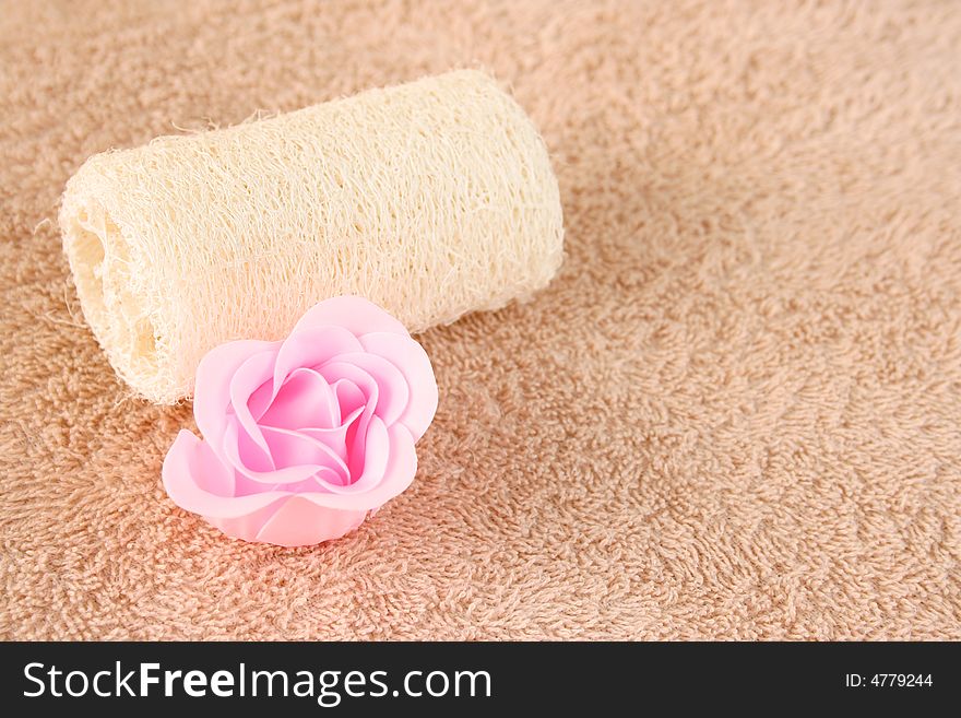 Pink soap flower and a skin scrub sponge