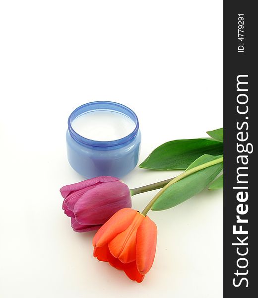 Red, violet tulips and body cream, isolated on white background. Red, violet tulips and body cream, isolated on white background.