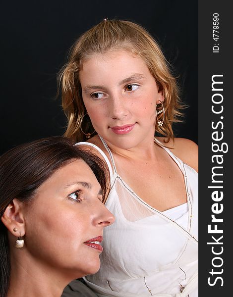 Beautiful mother and daughter on a black background