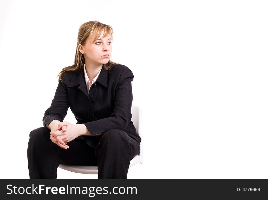 Businesswoman sitting on the chair and looking sideway/ copyspace