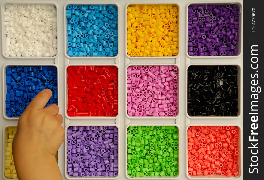 Child playing with toy pearls