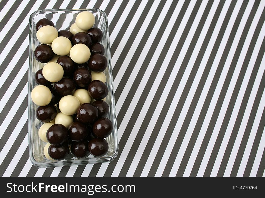 Vanilla and Dark Chocolate balls on a striped background