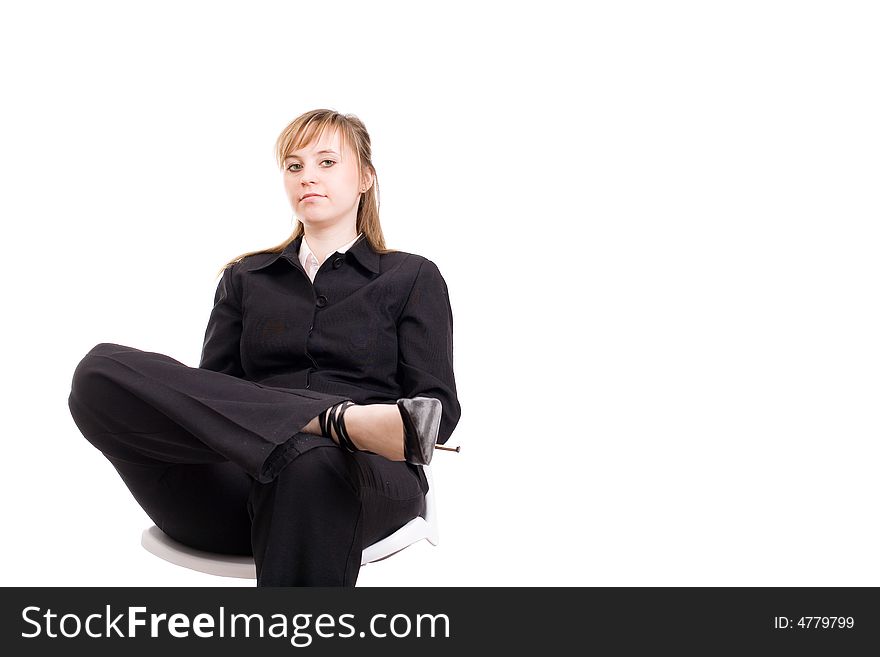 Businesswoman sitting on the chair and looking at the camera/ copyspace