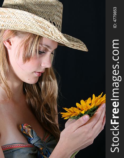 Beautiful young female model holding a sunflower