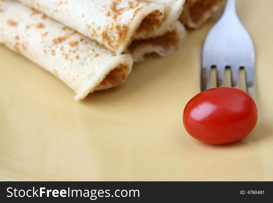 Barbeque Chicken Pancakes with a single tomato