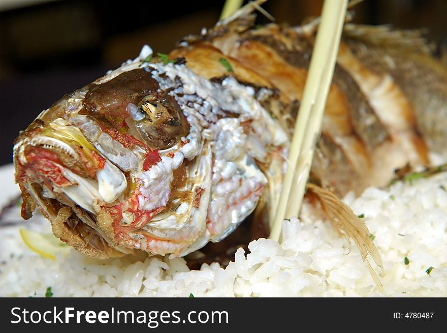 Whole prepared fish with rice