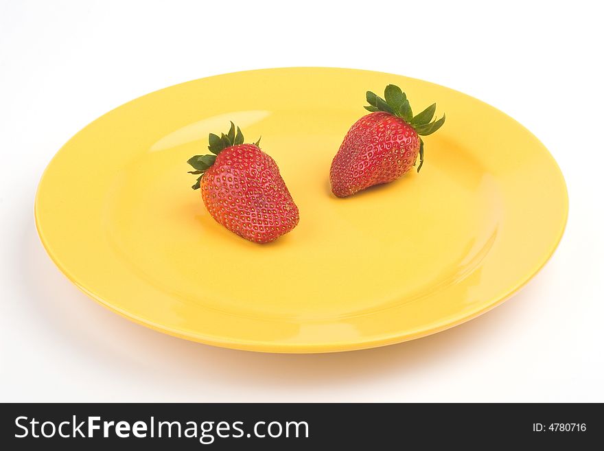 Two strawberry on yellow plate. Two strawberry on yellow plate