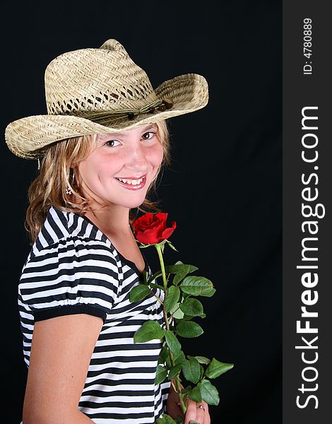 Teenage girl with a straw hat and red rose. Teenage girl with a straw hat and red rose