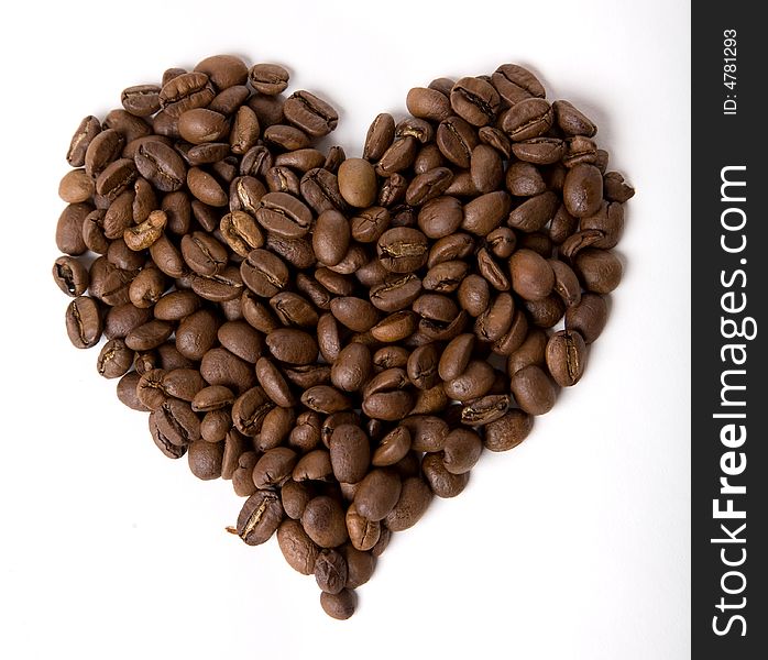 Coffee heart made of beans on white background