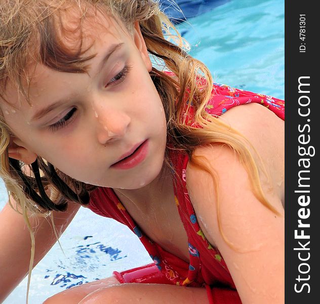 This is my daughter comng out of the pool all wet in florida wth a funny look on her face with the water dripping of her face and hair. This is my daughter comng out of the pool all wet in florida wth a funny look on her face with the water dripping of her face and hair