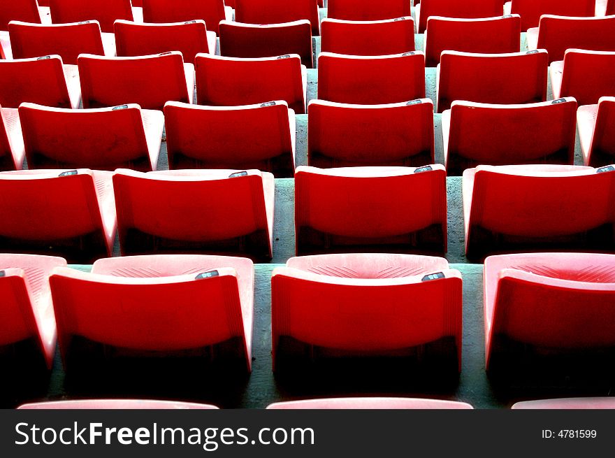 Rows of chairs in perfect line and symmetry vacant to anyone. Rows of chairs in perfect line and symmetry vacant to anyone.