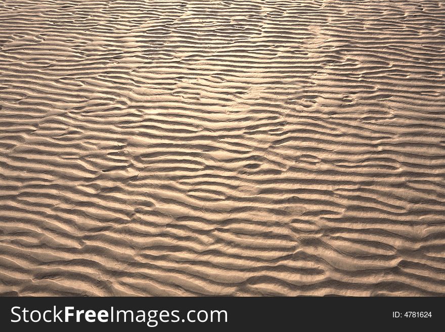 Rippled sand on picturesque beach.