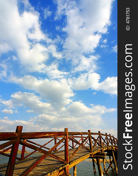 Wooden arch  bridge under the sky and clouds. Wooden arch  bridge under the sky and clouds