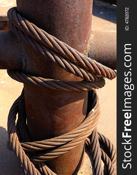 Rusty steel rope with bollard