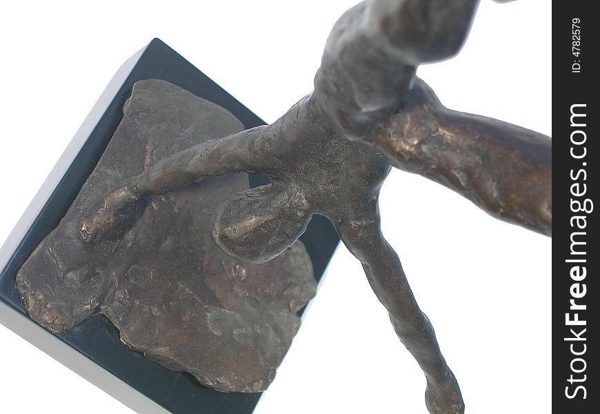 Close up of a bronze statue of a gymnast standing on one hand spreading legs over white background, side view. Close up of a bronze statue of a gymnast standing on one hand spreading legs over white background, side view