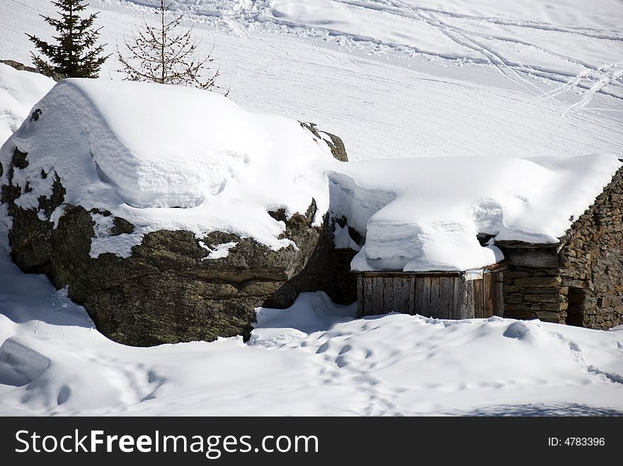 Mountain hut under snow