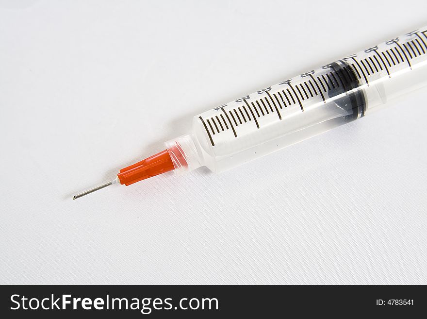 Close up of a Syringe with a safety needle on it. Close up of a Syringe with a safety needle on it.