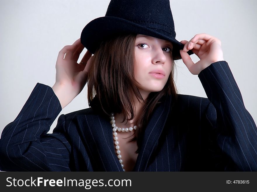 Beauty young woman in black hat at white background