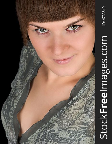 Portrait of beautiful women in green skirt looking up on black background