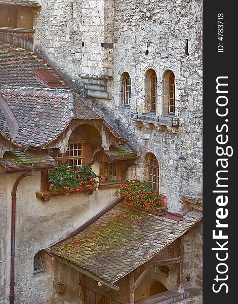 A serf court and the walls decorated by flowers in pots. A serf court and the walls decorated by flowers in pots