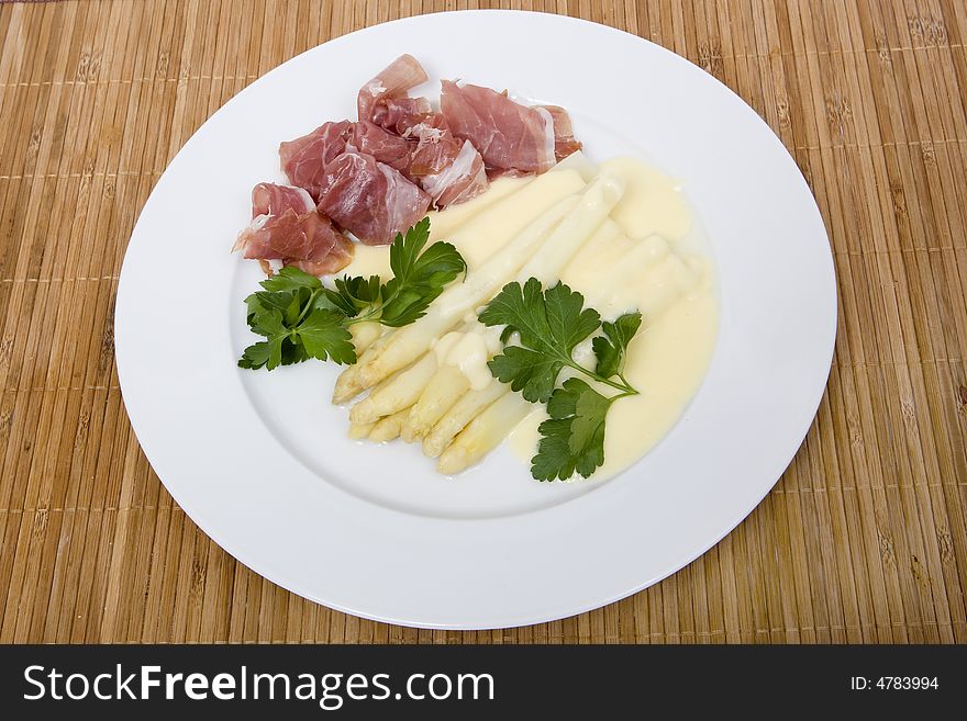 White asparagus with ham and hollandaise sauce for gourmets