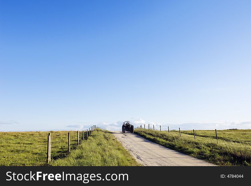 Tractor moving away in a beautiful country road.  Alentejo, Portugal