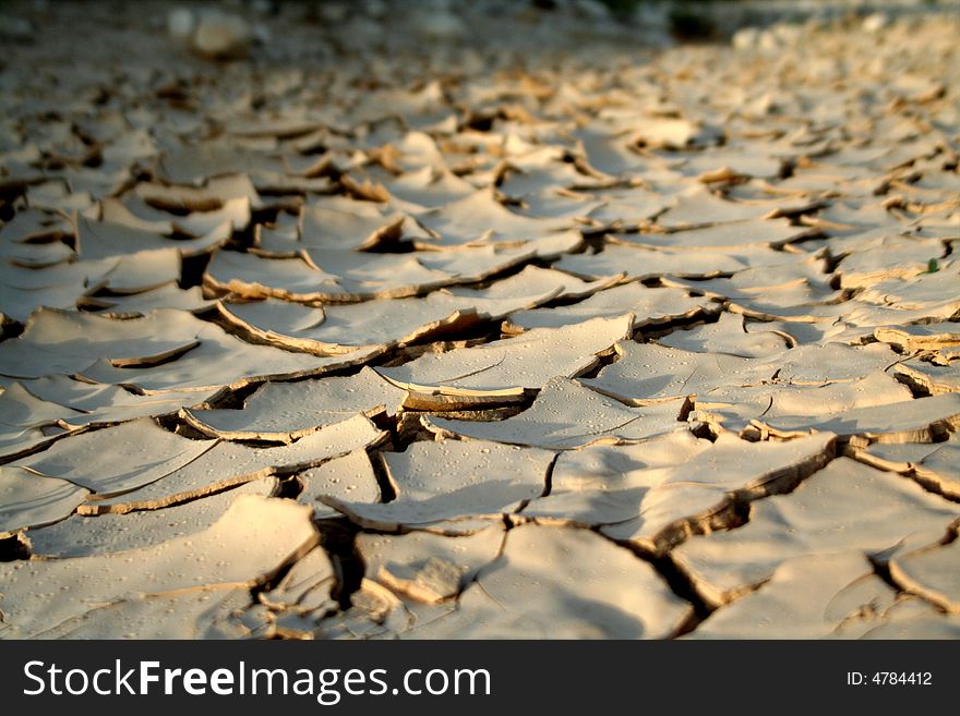 Dry mud creative cracks in the desert land. Dry mud creative cracks in the desert land.