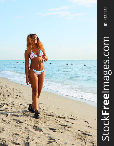 Woman in boots walking on the beach. Woman in boots walking on the beach