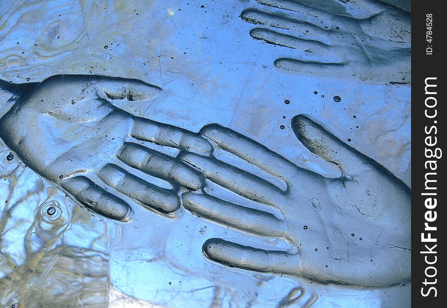 Print of two hands in glass. Print of two hands in glass