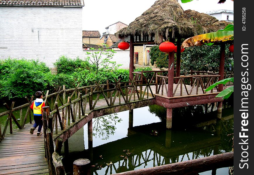 Water country view in Canton,China.wood corridor and thatched pavilion on the water. Water country view in Canton,China.wood corridor and thatched pavilion on the water.