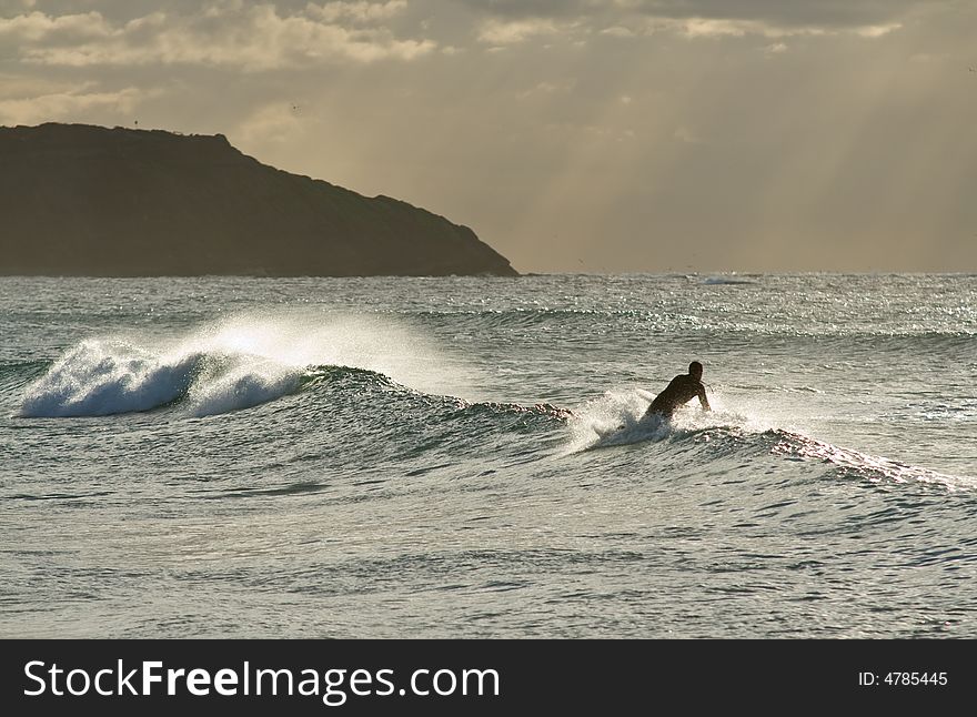 A bodyboarder rides a wave in one of many Australias beaches. A bodyboarder rides a wave in one of many Australias beaches