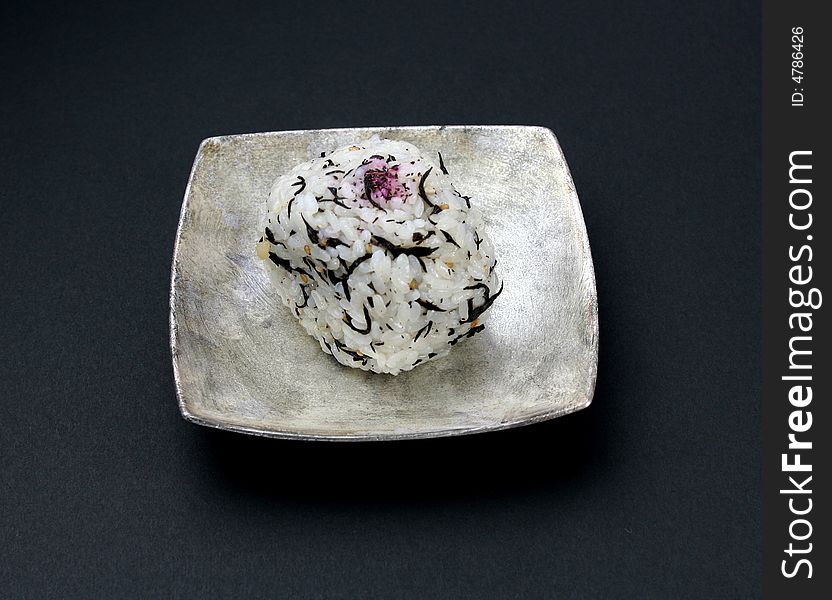 A rice ball on the silver dish