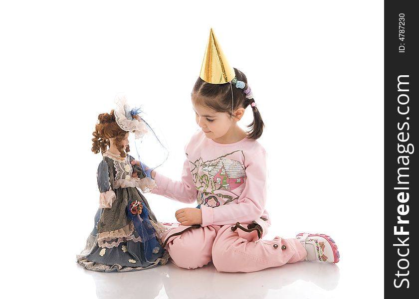 The little girl with a doll isolated on a white background