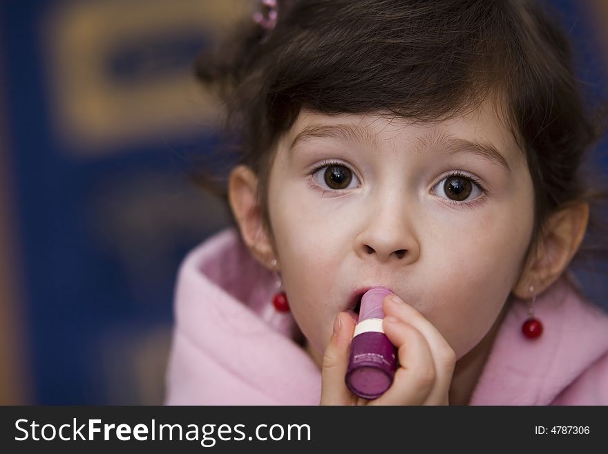 Young girl with lipstick in the pink  sweatshirt