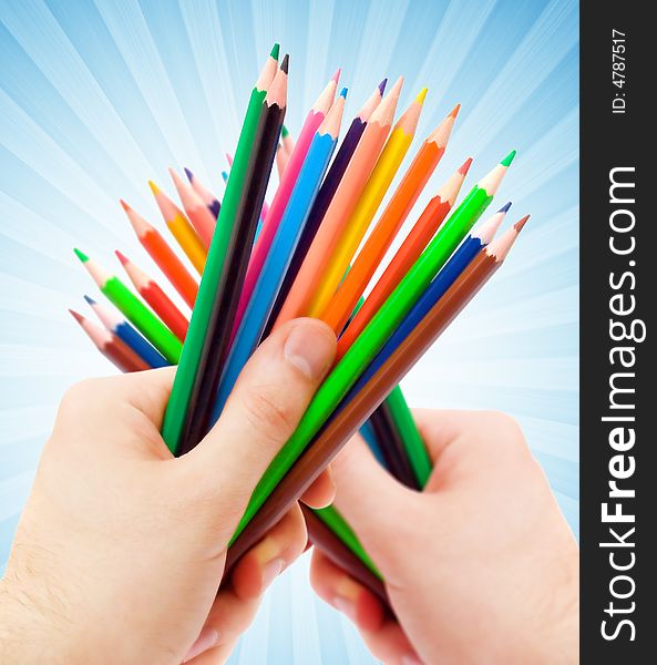 Human hand holding color pencils. Human hand holding color pencils