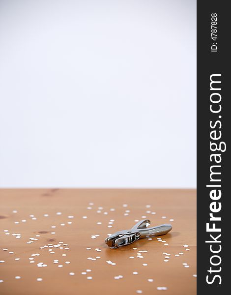 A hole punch on a desk in the office