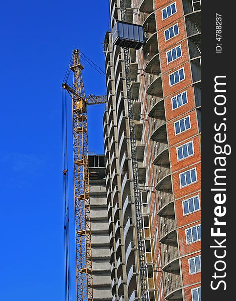 A under construction house on a background of the blue sky