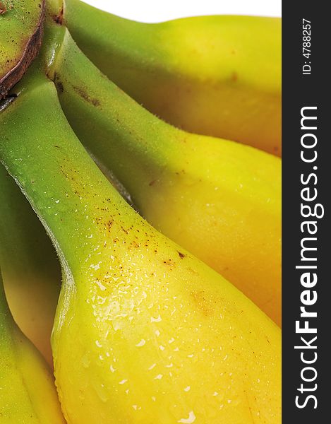 Close-up of at bunch of yellow bananas on white background