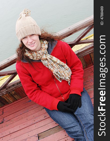 Woman on the deck of a boat dressed in winter clothing.