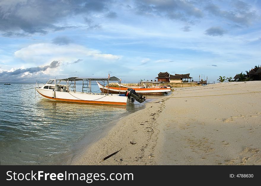 Tropical landscape with fishing boats on the beach