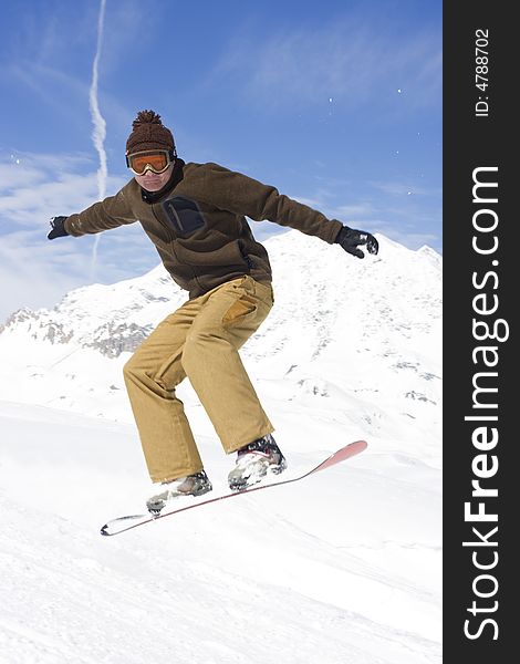 Snowboarder taking a jump in fresh snow